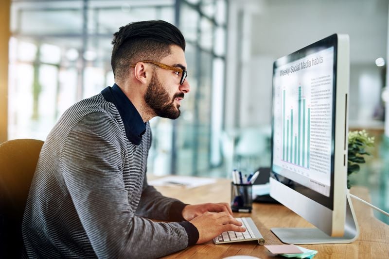 man using computer to look at graphs representing how to build a dynamic pricing model