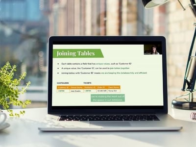 A laptop showing a webinar and slide deck