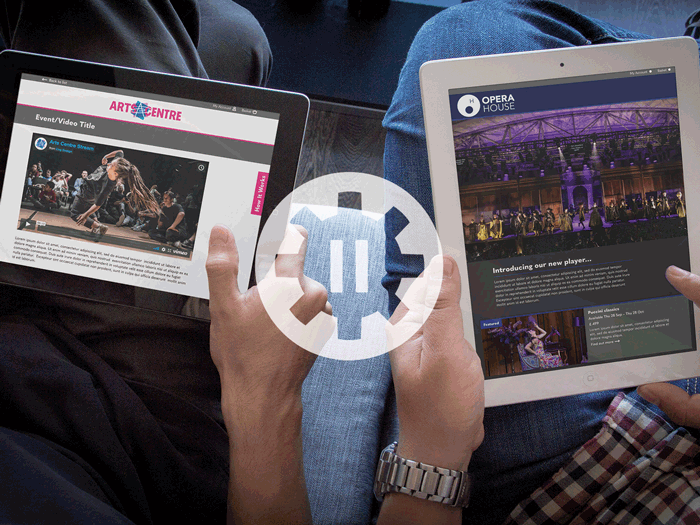 Two people looking at CogPlayer content on tablets, animated with a revolving cog