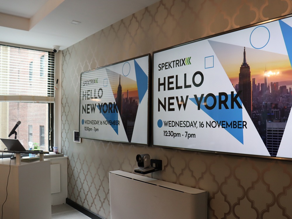 Hello New York on dual monitors in conference room