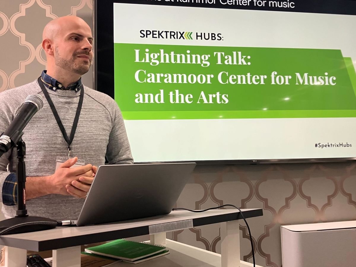 Alec, a bald man wearing a sweater, from Carmoor Center for Music and the Artspresents a lightning talk