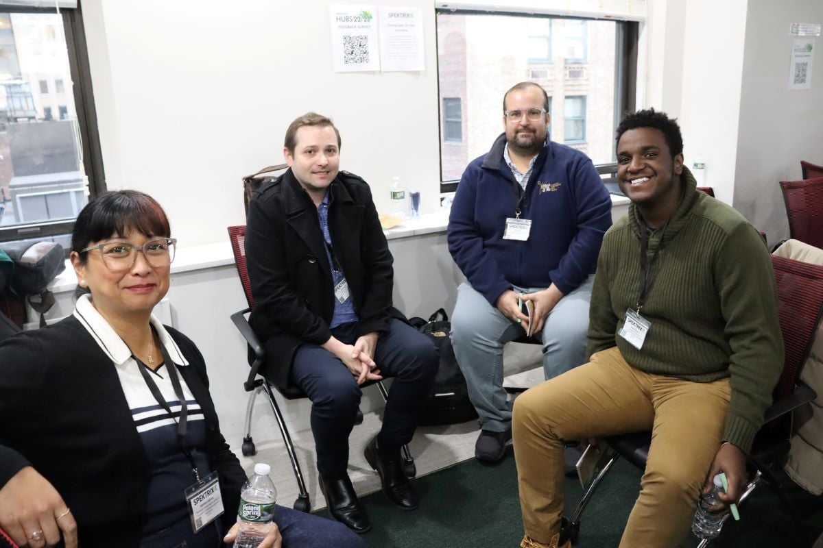 group of four breaking from conversation for a photo
