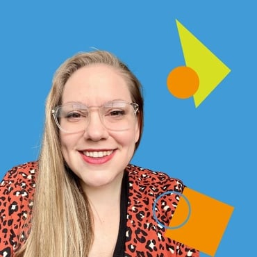 Bethany Nothstein, a white woman with blonde hair and glasses wearing a black shirt and leopard print jacket smiling at the camera.