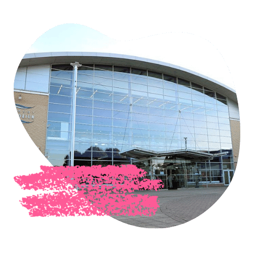 Exterior of Grimsby Auditorium, a large glass-fronted building