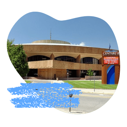 Music Theatre Wichita is a low, red building against green grass