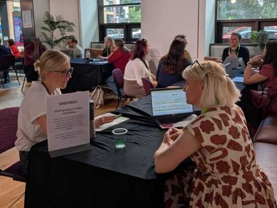 People having a conversation at Spektrix Hubs 2025 in London.