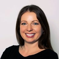 A portrait photo of a smiling Erin Caldwell with long, dark brown hair on a plain white backdrop.