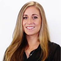 A professional portrait shot of Joni Erdmann, smiling at the camera