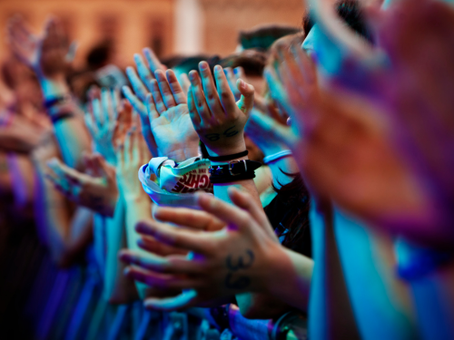 an image of the hands of audience members clapping