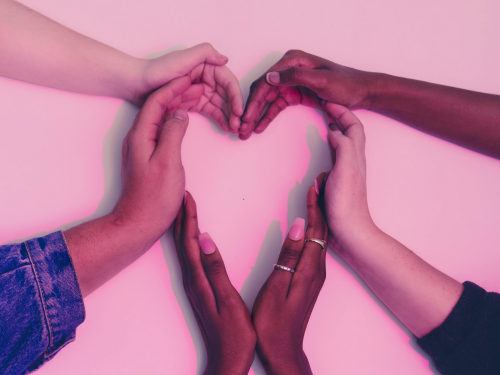an image of hands coming together to form a heart shape