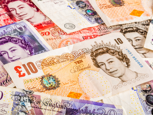 an image of british paper money piled together