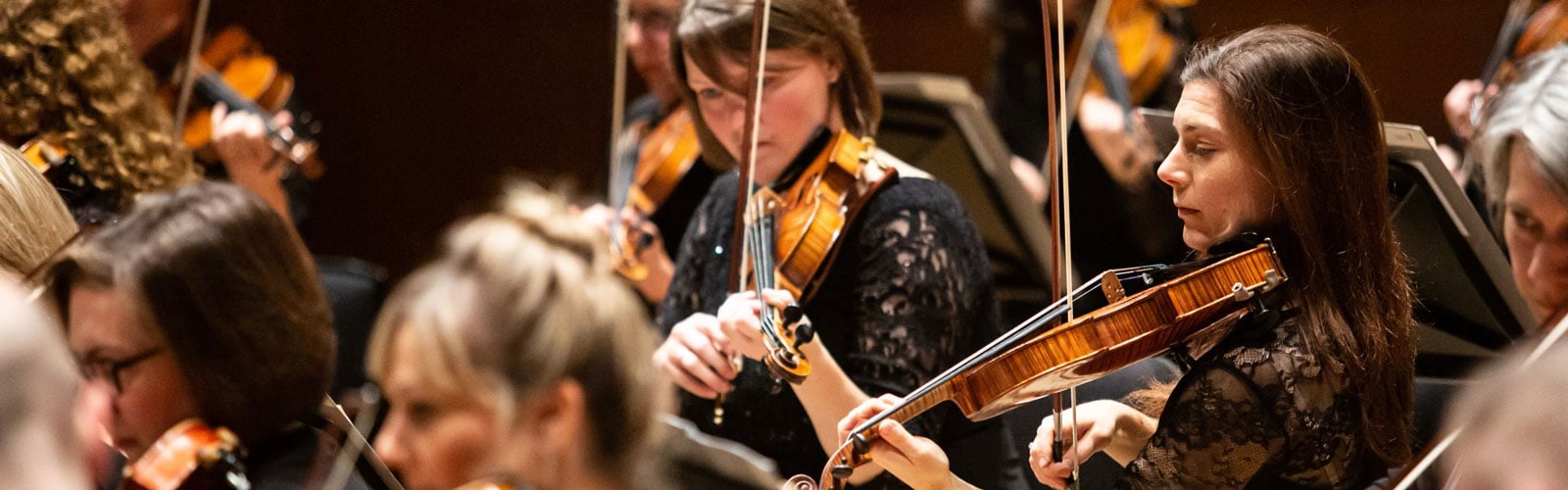Royal Scottish National Orchestra violins section, majority women in black dress