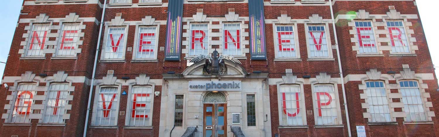 Window sized letters spell out never give up on the outside of Exeter Phoenix