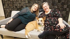 Two team members relax with the New York office dog
