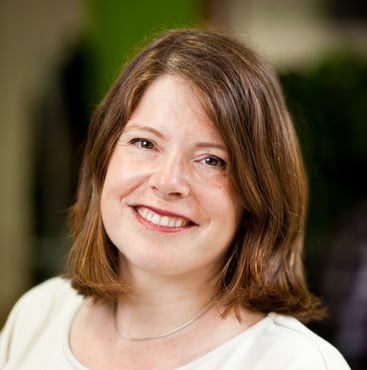 A headshot of Alice Young, a woman smiling into the camera