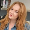 Samantha Bagwell, woman with long red hair wearing a denim jacket