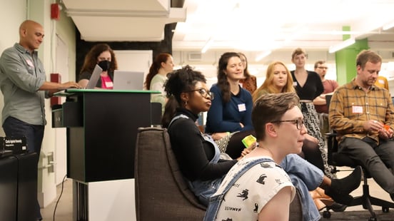 Spektrix team members gathered in the New York office, listening attentively to a speaker