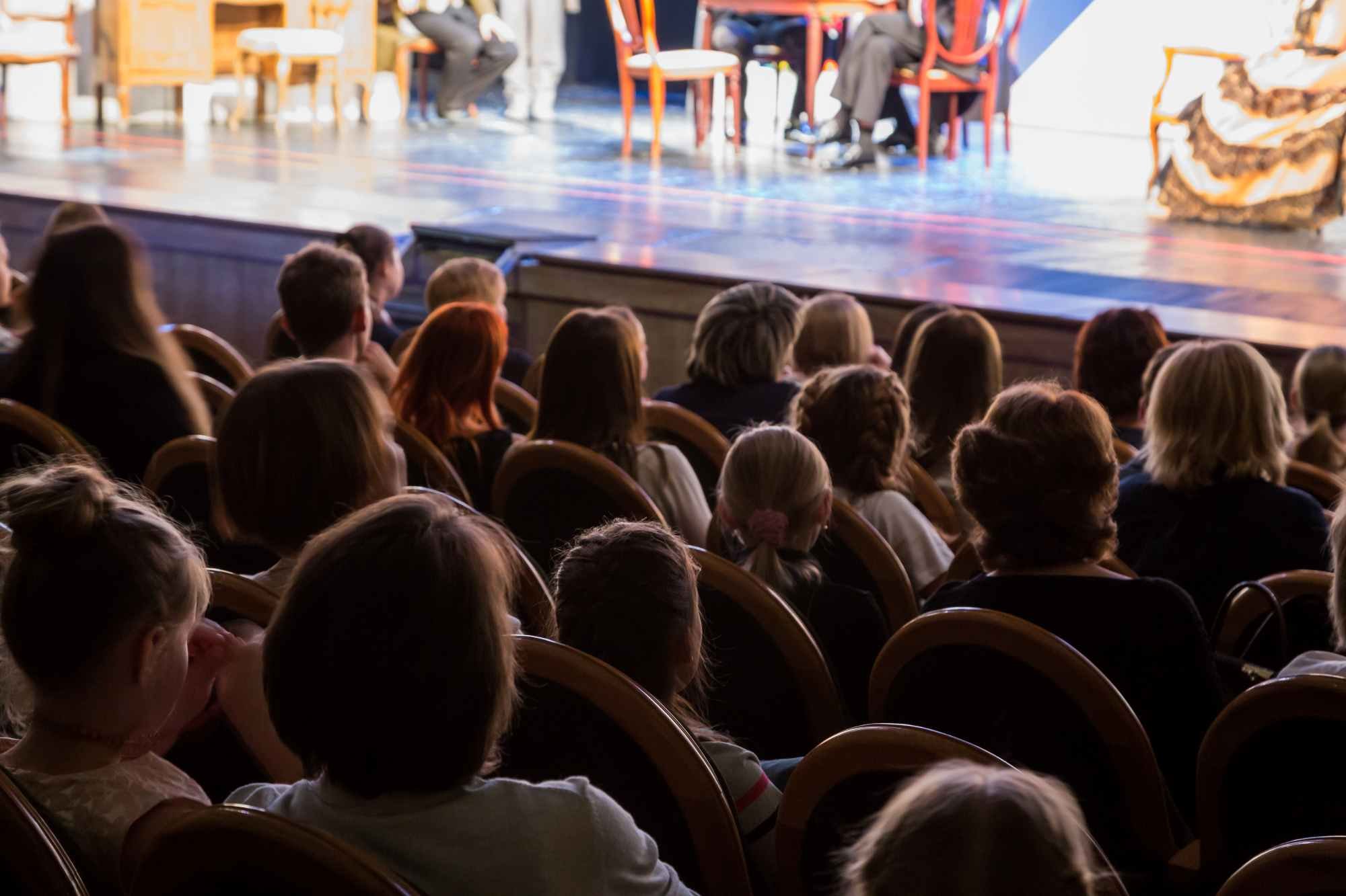 An audience watching a stage play.