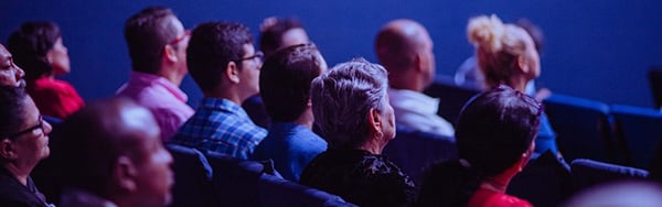 audience members seated in rows of seats