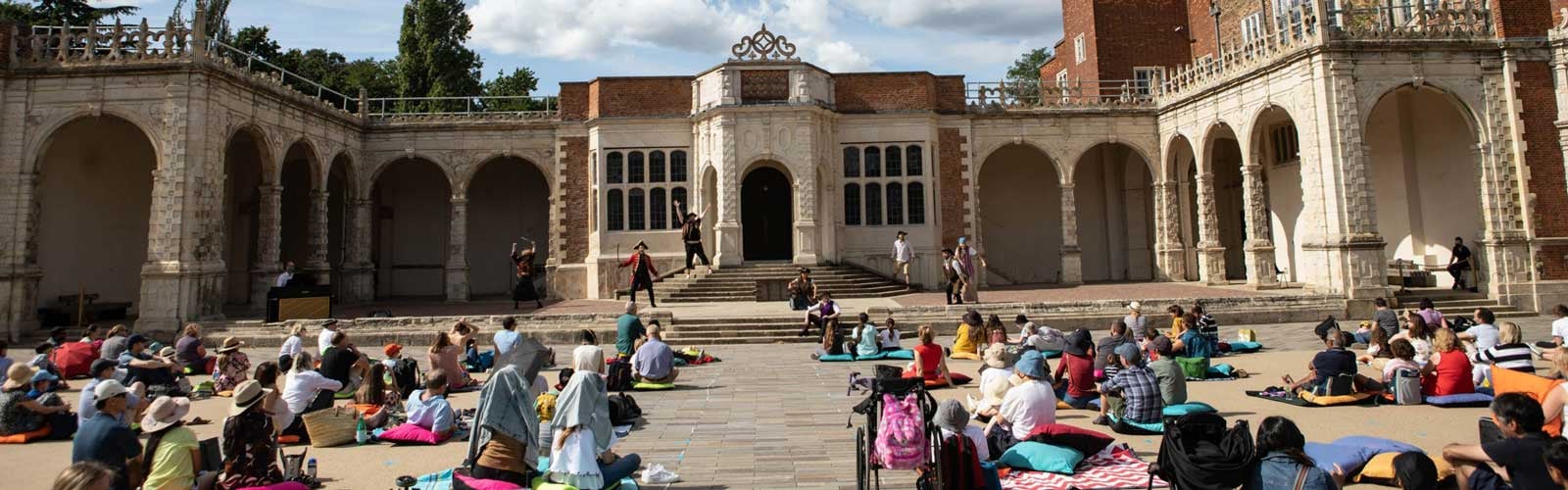 An audience watching Pirates of Penzance at Opera Holland Park