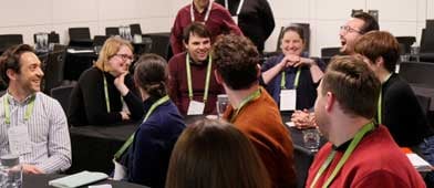 Spektrix conference attendees sitting in a circle talking