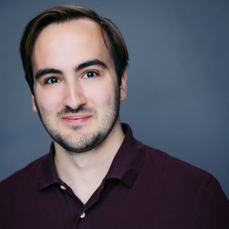 Patrick Kavanagh, Director, Ticketing and Box Office at Magic Mike, has dark hair and wears a deep burgundy polo.