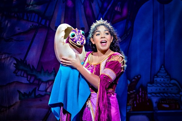 A performer in fairytale costume with a puppet dragon at Lawrence Batley Theatre