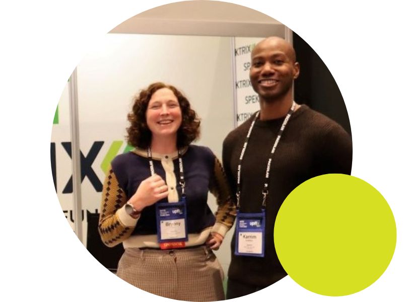 UK and US team members together at a conference exhibit booth