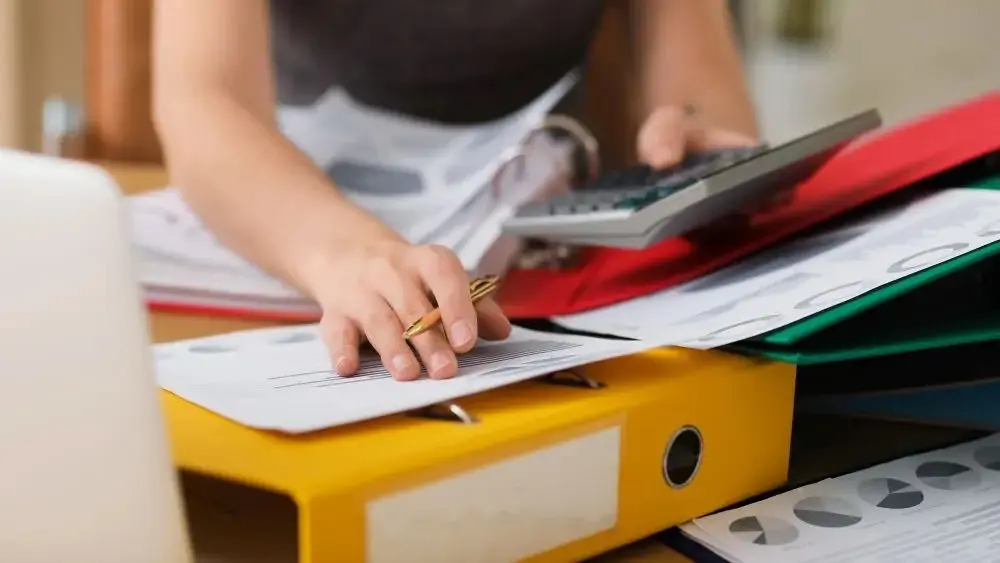 Accountant Messy Binders 100W 667H Adobestock 580426150