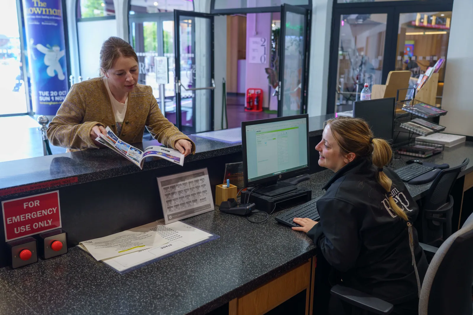 Binghamton Rep Box Office Worker Helping Ticket Program Customer Smiling