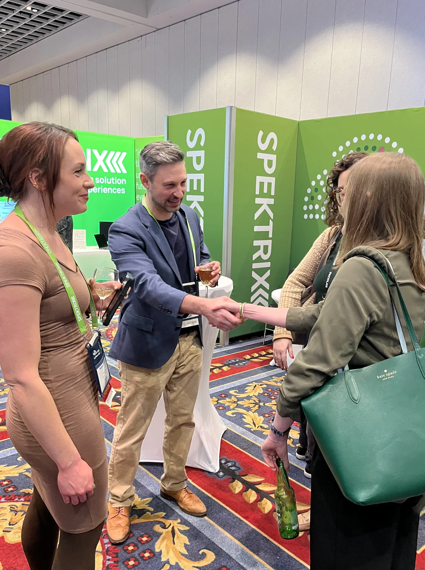 Mike And Karen Speaking And Shaking Hands With Attendees Intix Booth 2026 E1783529640580
