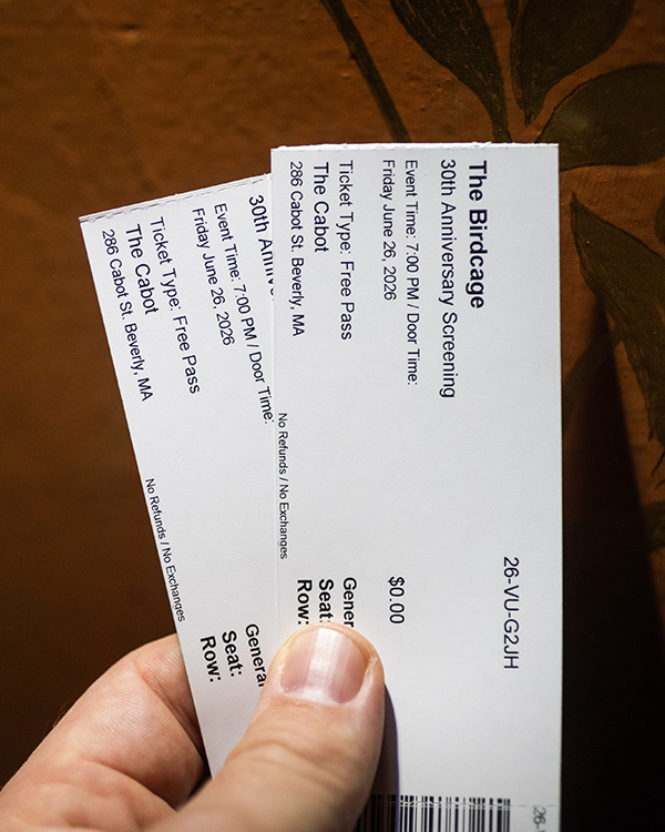 A Hand Holding A Pair Of Tickets