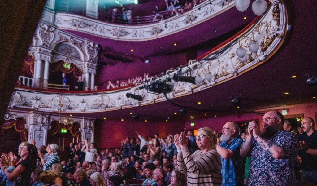 Audience Members Stand And Applaud Across The Ornate Lyceum Stalls And Balconies.